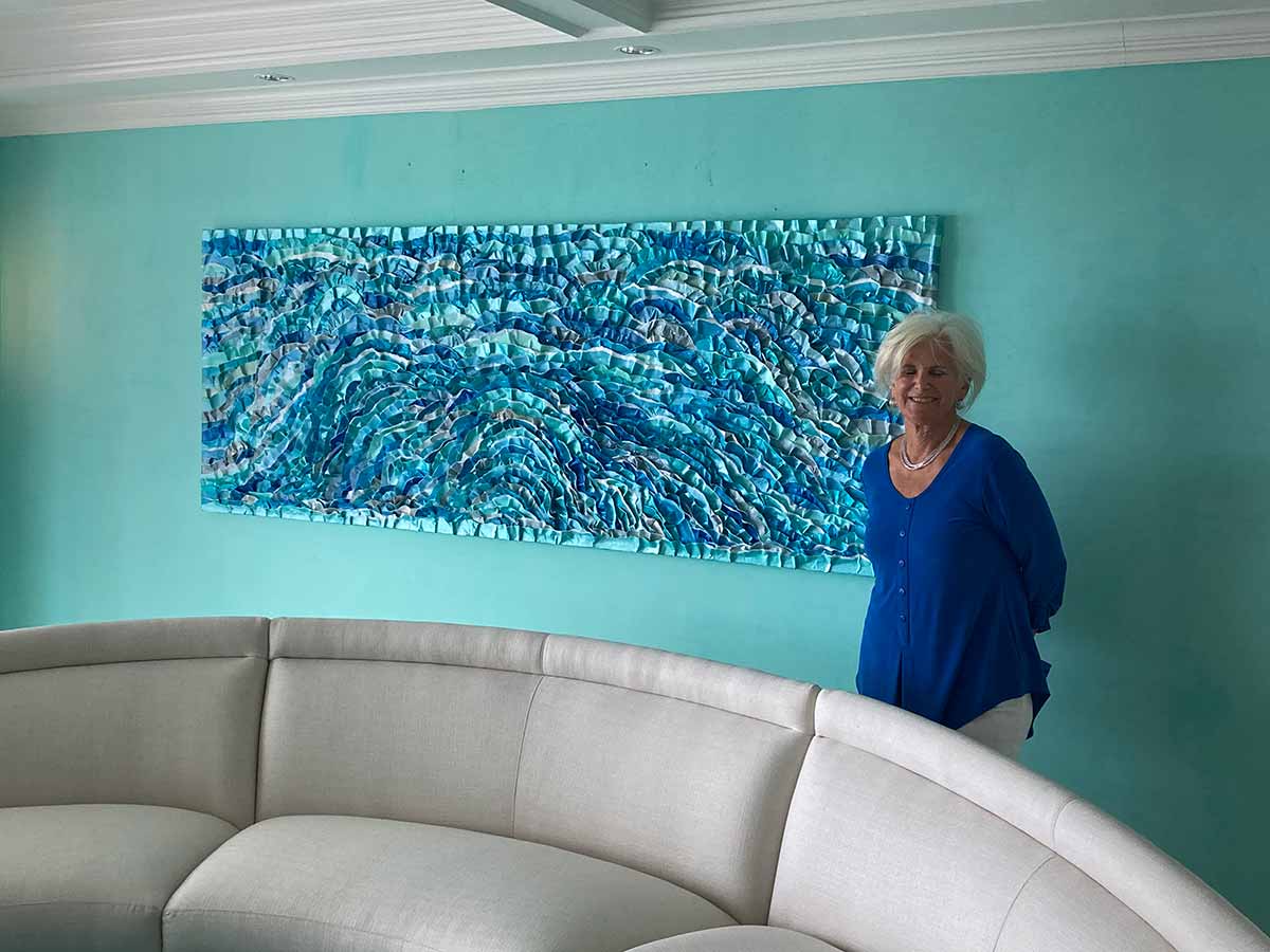 Paula Brody in front of a commissioned painting